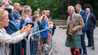 King Charles III meets members of the public after the inspection of Balaklava Company, 5th Battalion, The Royal Regiment of Scotland, at the gates of Balmoral, as he takes up summer residence at Balmoral Castle on August 21, 2023 in Aberdeen, Scotland. (Photo by Jane Barlow - Pool/Getty Images)