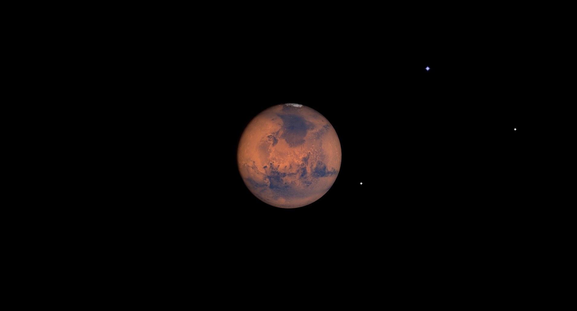 A close up of Mars in space, showing its reddish brownish surface.