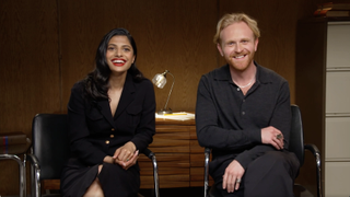 a female and male actor in a press room