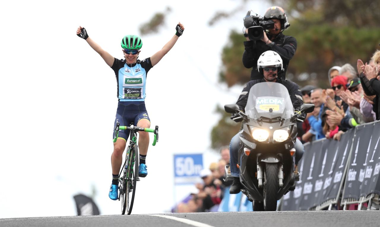 Amanda Spratt raises her arms in triumph