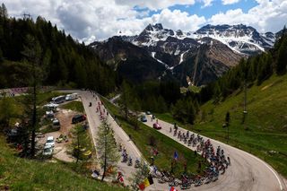 TOPSHOT Riders of the pack cycle through the Passo di Campolongo pass during the nineteenth stage of the Giro dItalia 2023 cycling race 183 km between Longarone and Tre Cime di Lavaredo rifugio Auronzo on May 26 2023 Photo by Luca BETTINI AFP Photo by LUCA BETTINIAFP via Getty Images