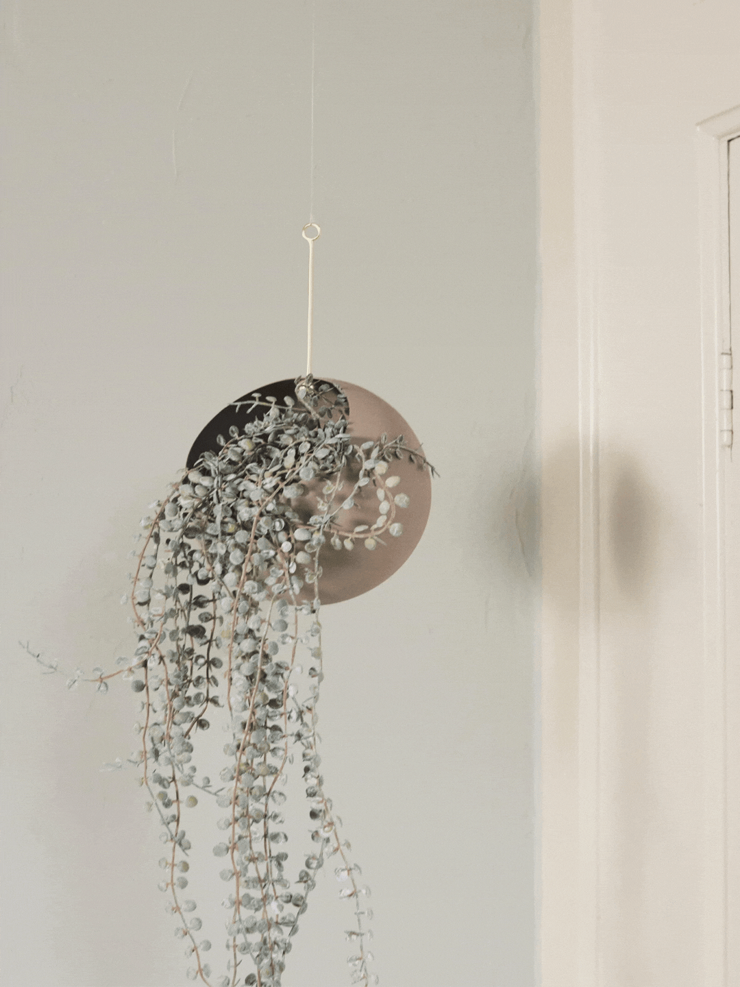 A beige hanging planter from AYTM