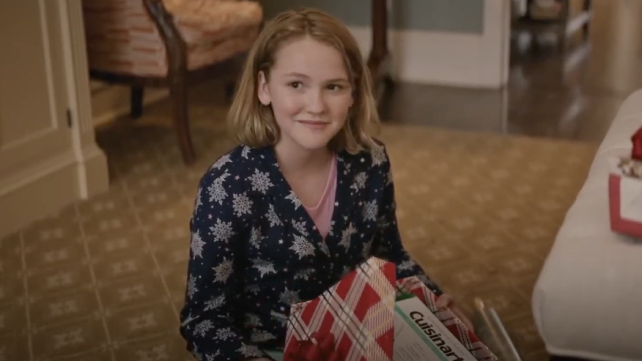 Nora opening up Simon's Christmas present in Love, Simon.