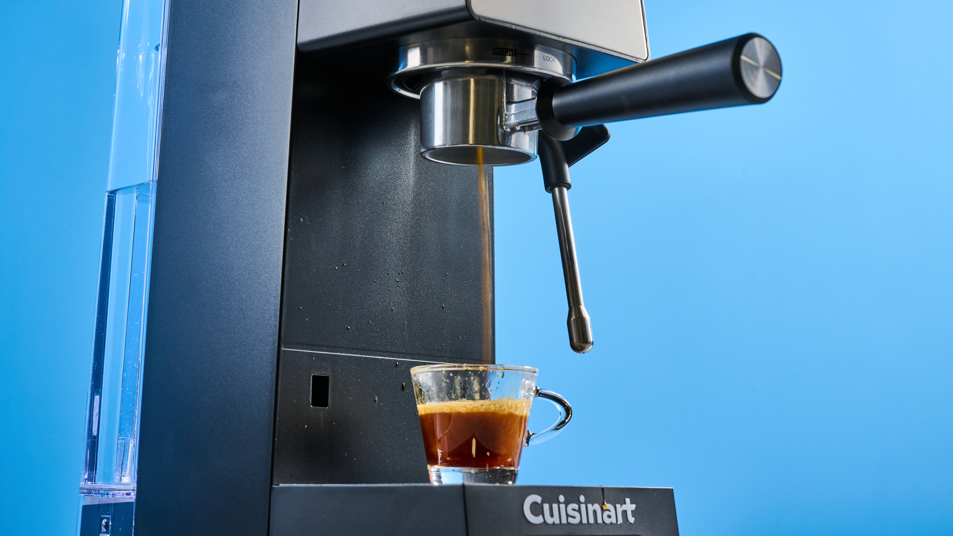 The Cuisinart Espresso Bar Slim espresso machine on a stone surface with a blue background
