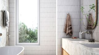 Contemporary light bathroom with tall thin tiles on wall and around window with bath and sink in foreground