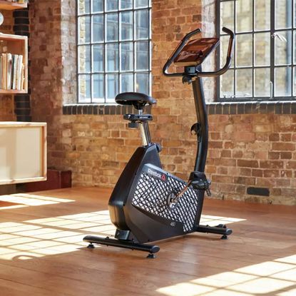 Reebok ZJET 460 Bluetooth Exercise Bike in a bright room with wooden floors.