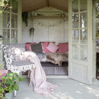 summerhouse shed with sofa and plant