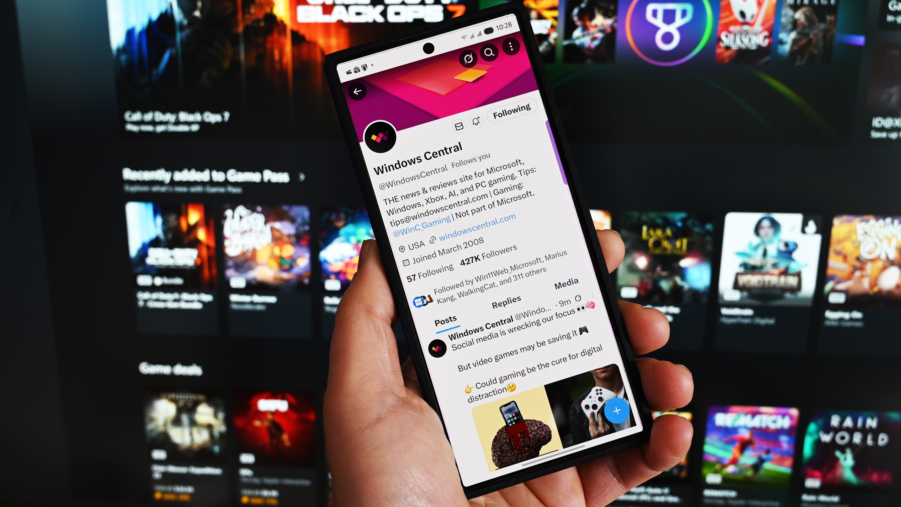 Twitter running on a Samsung Galaxy phone with the Xbox app for Windows in the background.