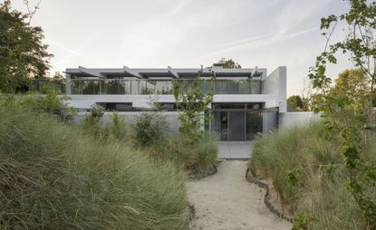 Concrete and glass house in nature