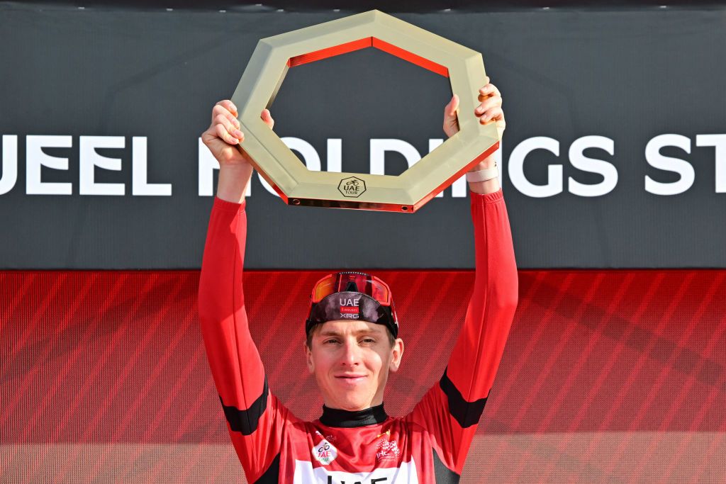 UAE Team Emirates&#039; Slovenian rider Tadej Pogacar celebrates on the podium with the trophy after winning the 2025 UAE Tour in Jebel Hafeet on February 23, 2025. (Photo by Giuseppe CACACE / AFP)