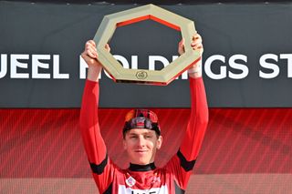 UAE Team Emirates' Slovenian rider Tadej Pogacar celebrates on the podium with the trophy after winning the 2025 UAE Tour in Jebel Hafeet on February 23, 2025. (Photo by Giuseppe CACACE / AFP)