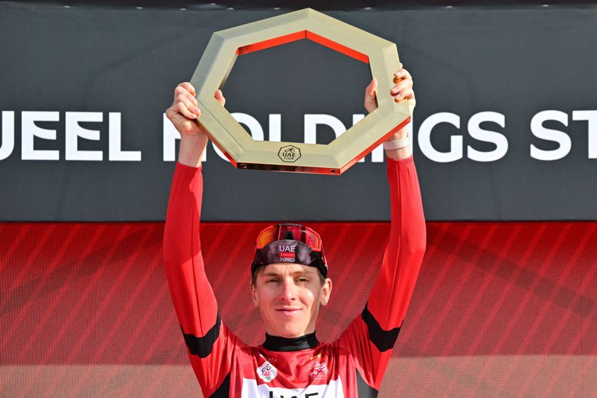 UAE Team Emirates&#039; Slovenian rider Tadej Pogacar celebrates on the podium with the trophy after winning the 2025 UAE Tour in Jebel Hafeet on February 23, 2025. (Photo by Giuseppe CACACE / AFP)