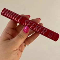 hand holding rimmel london thrill seeker mascara