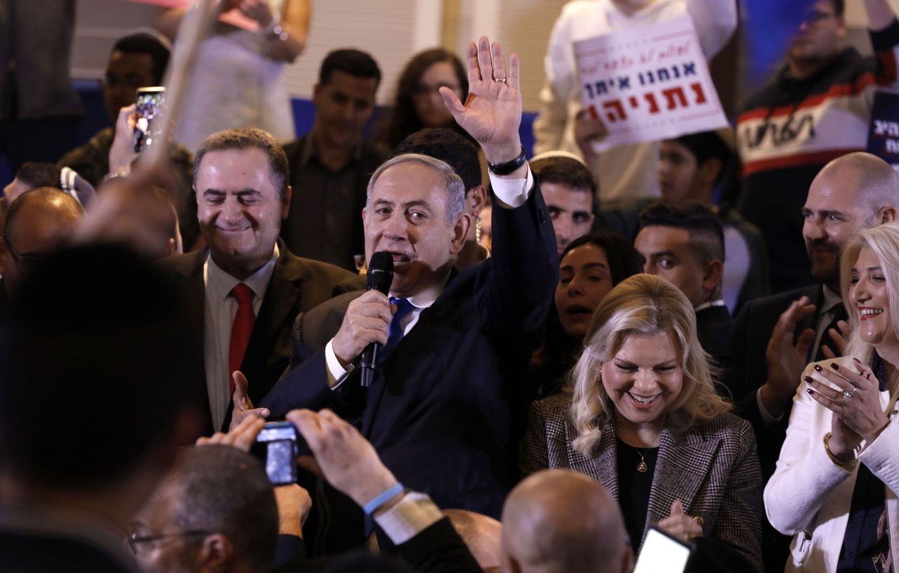 Israeli Prime Minister Benjamin Netanyahu waves to supporters during a Likud party campaign rally in Jerusalem on February 26, 2020. To his right stands his wife Sarah. - Next week&amp;#039;s election