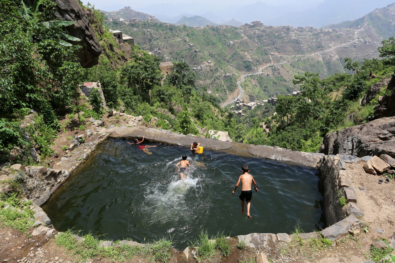 Boys swim in a pond in the mountains, in the Jafariya district of the western province of Raymah, Yemen.