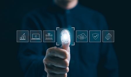 Futuristic biometric authentication technology concept. Man is touching a fingerprint scan with icons of secured access, data protection, network cyber security in digital interface.