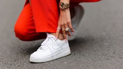 Patricia Gloria Contreras wears a Rolex watch, Nike white sneakers, on April 08, 2021 in Paris, France