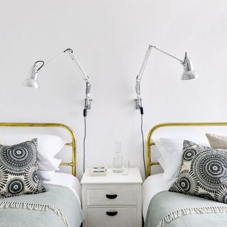 white twin bedroom with brass bedsteads