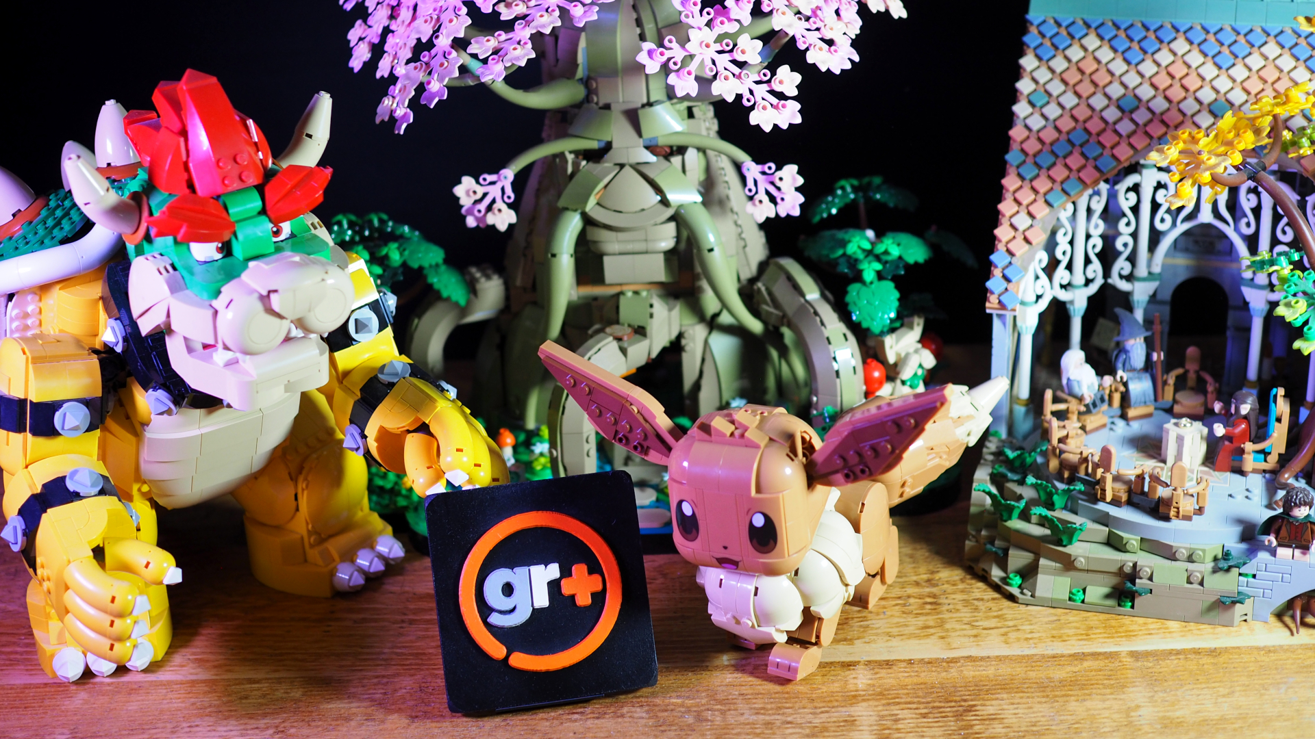 Lego The Mighty Bowser, Eevee, Great Deku Tree, and Rivendell laid out behind the GamesRadar+ logo