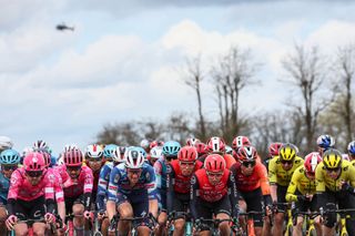 The pack of riders cycles during the 2nd stage of the Paris-Nice cycling race, 183,9 km between Montesson and Bellegarde, on March 10, 2025. (Photo by Anne-Christine POUJOULAT / AFP)