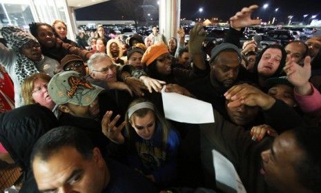 Eager Black Friday shoppers in Griffith, Indiana are seen waiting in line to receive vouchers outside of Kmart on Nov. 22.