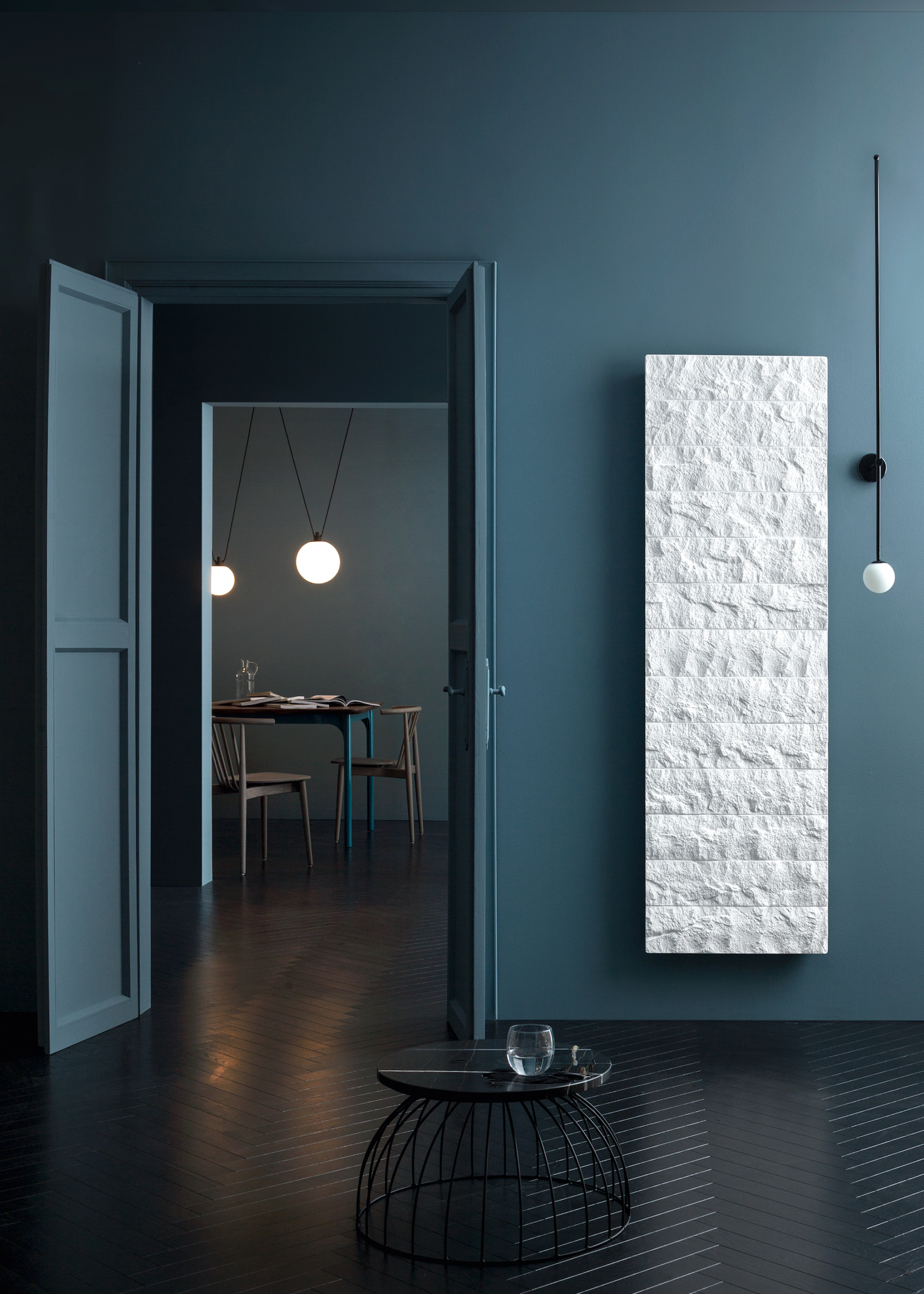 A dark blue bathroom with a textured white panel radiator featuring