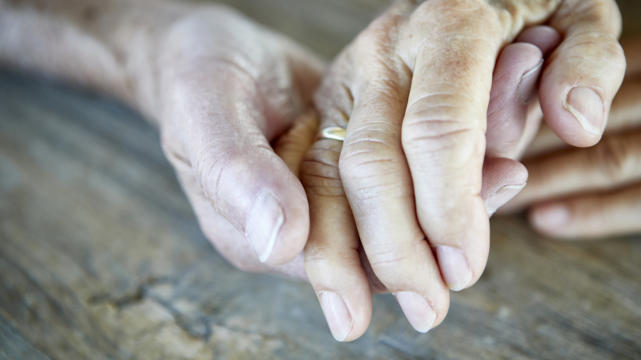 elderly couple holding hands