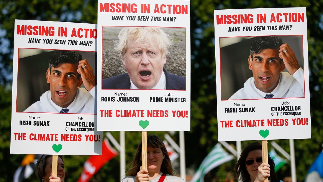 Protesters hold &amp;#039;Missing in Action&amp;#039; style placards of Prime Minister Boris Johnson and Chancellor Rishi Sunak with the phrase &amp;#039;The climate needs you!&amp;#039; 