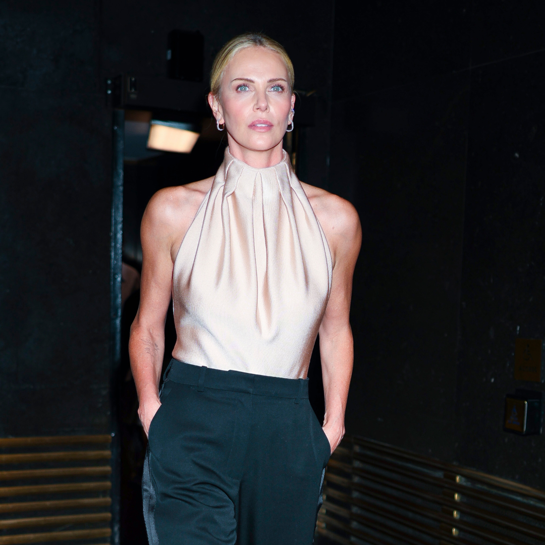 Charlize Theron wearing a low ponytail hairstyle and a halterneck top
