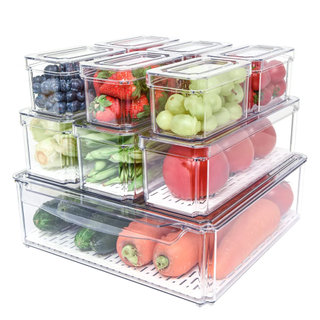 A set of clear fridge containers filled with fruits and vegetables