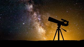 the silhouette of a telescope in front of a starry night sky