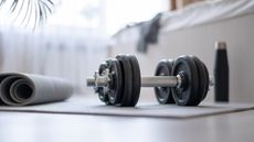 Home weights set deals: Here, an image of a set of dumbbells in a bedroom.