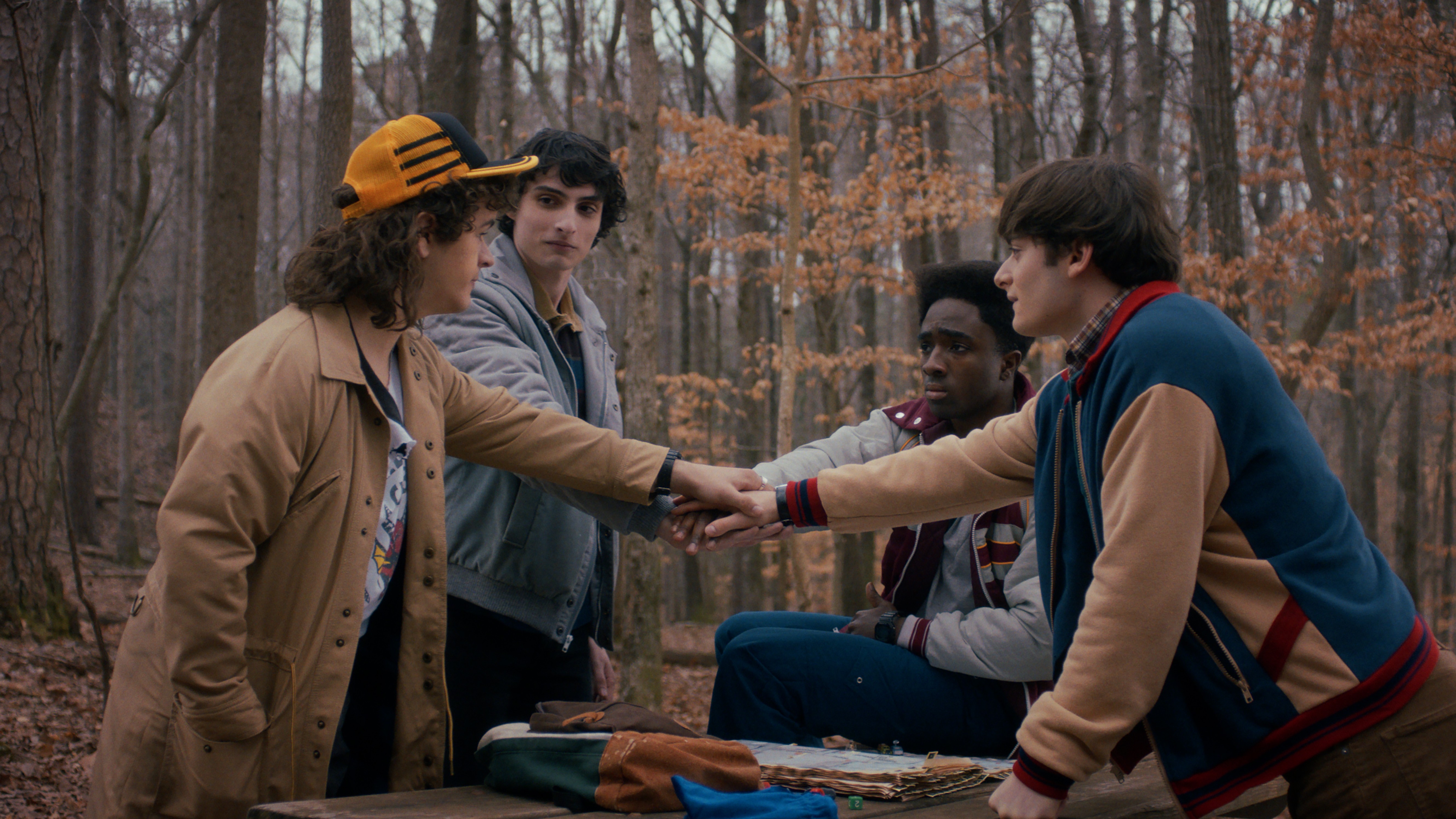 The original "Stranger Things" boys do hands-in in a scene from "Stranger Things" season 5