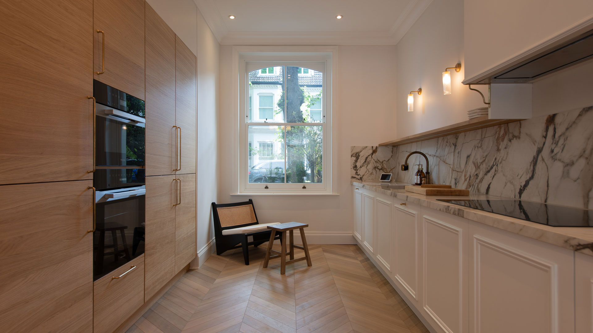 wooden and white kitchen with chevron pattern wooden flooring