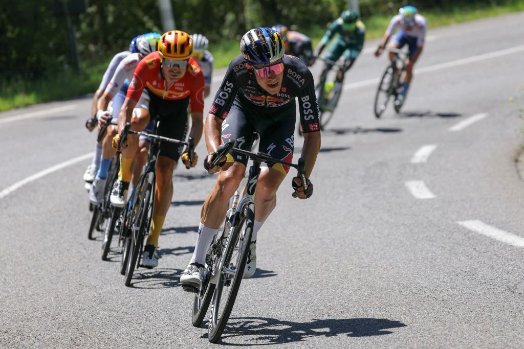 Red Bull - BORA - hansgrohe team's Luxembourgish rider Bob Jungels cycles ahead of Uno-X Mobility team's Danish rider Magnus Cort in a breakaway during the 15th stage of the 111th edition of the Tour de France cycling race, 197,7 km between Loudenvielle and Plateau de Beille, in the Pyrenees mountains, southwestern France, on July 14, 2024. (Photo by Thomas SAMSON / AFP)