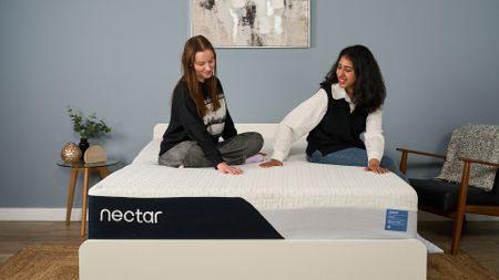 Mattress testers Frances Daniels and Becky George sit on the Nectar Classic Memory Foam Mattress in the Tom's Guide Sleep Lab