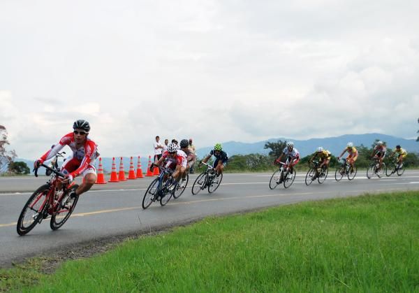 Racers fly around a corner