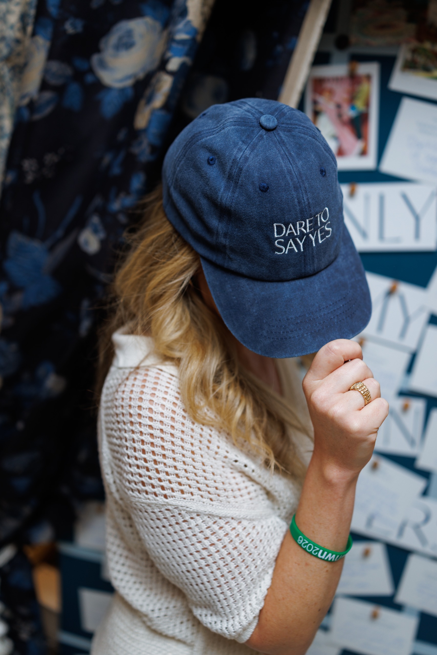 A blonde woman wearing an Anthology hat saying 'dare to say yes'