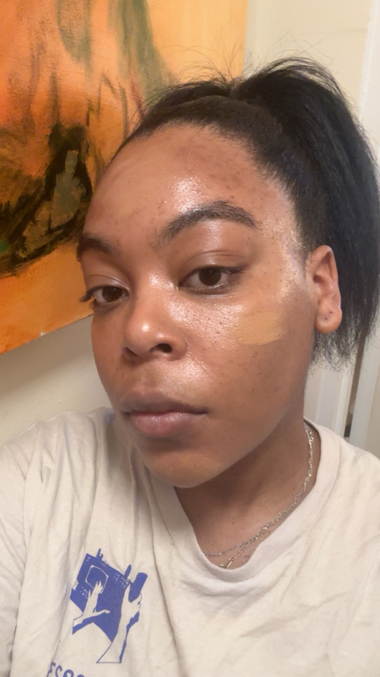 Ariel Baker with half a face of foundation