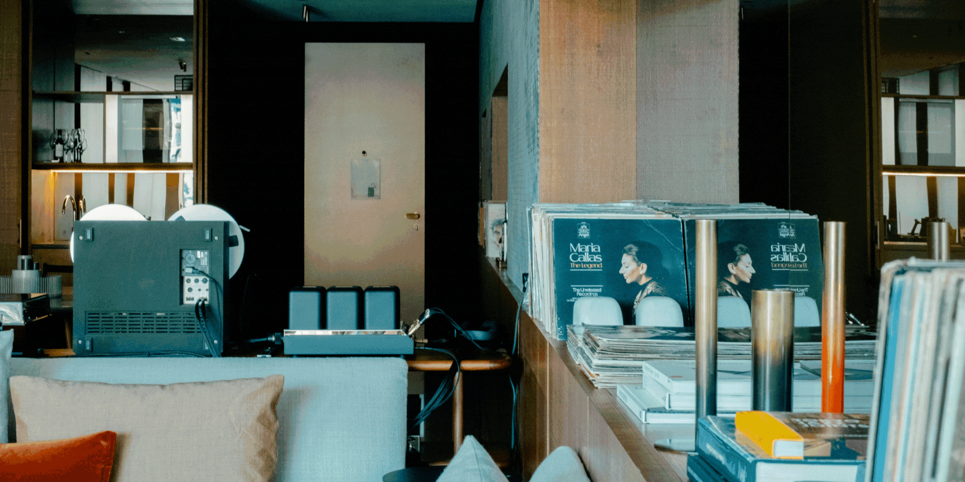 A recurring gif capturing the softly glowing mid-century modern interiors of a listening suite filled with music gear.