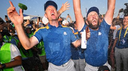 Justin Rose and Jon Rahm of Team Europe celebrate winning the Ryder Cup during the Sunday singles matches of the 2023 Ryder Cup at Marco Simone Golf Club on October 01, 2023 in Rome, Italy.