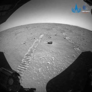 A hazard avoidance camera shot showing fresh Zhurong tracks in the Martian surface.