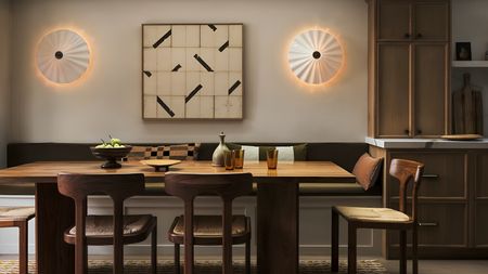 A dark wood dining table in front of a kitchen banquet bench. Four matching wooden dining chairs around it. 