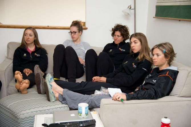 Women's team riders Leah Kirchmann, Denise Ramsden, Jade Wilcoxson, Janel Holcomb and Lauren Hall listen to the day's training schedule in the team condo.