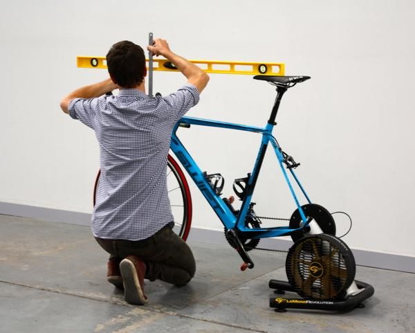 Ken Ballhause checks the difference between handlebar and saddle height on Lachie Norris' rig