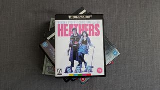 HMV Arrow Films 4K Blu-ray collection listing image with Heathers 4K Blu-ray on a pile of other discs 