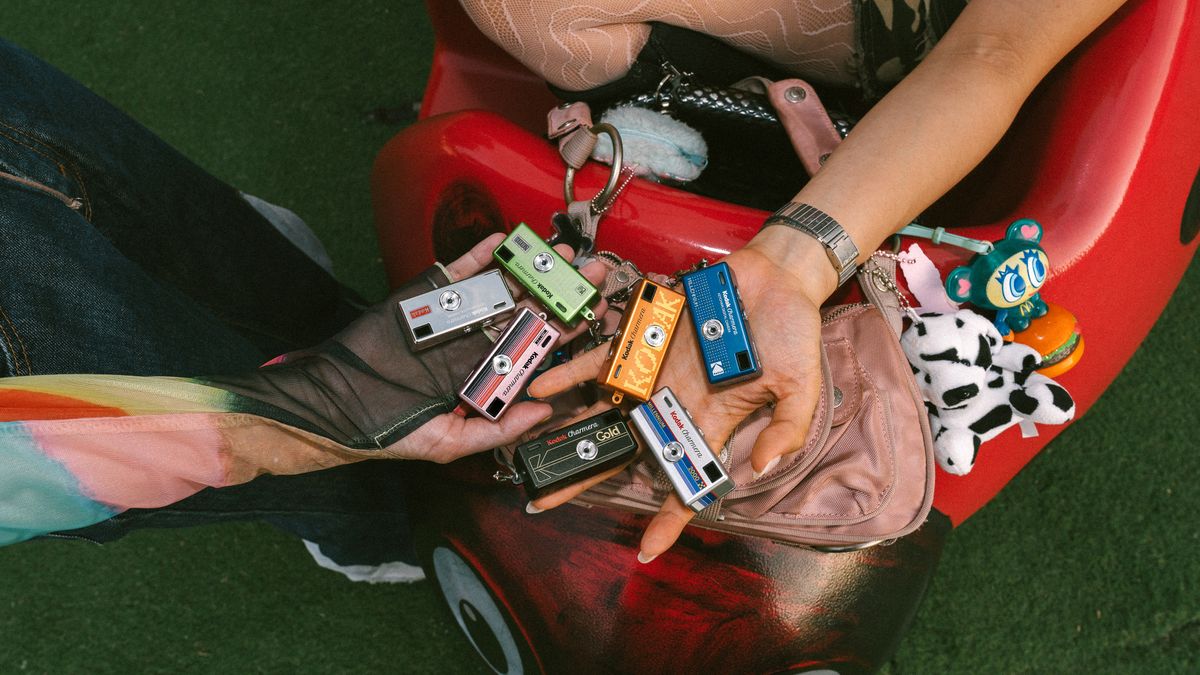 Several Kodak Charmera Millennium edition cameras in someone's hand