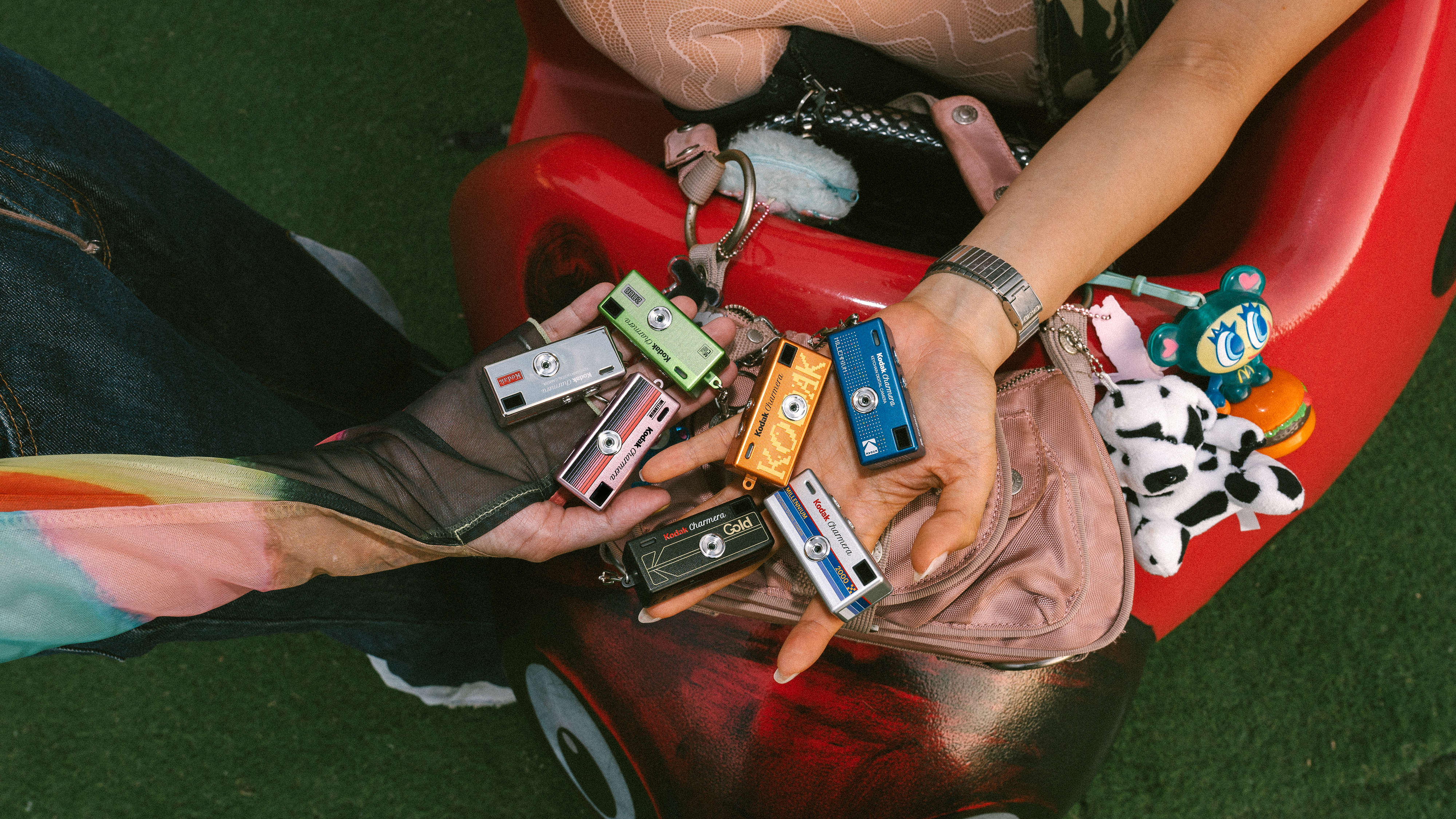 Several Kodak Charmera Millennium edition cameras in someone's hand