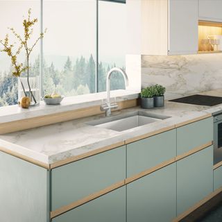 Kitchen with grey cabinet and wash basin with faucet