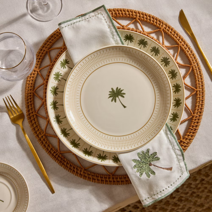 Primark The Edit tableware - palm side plate on a rattan placemate with gold cutlery.